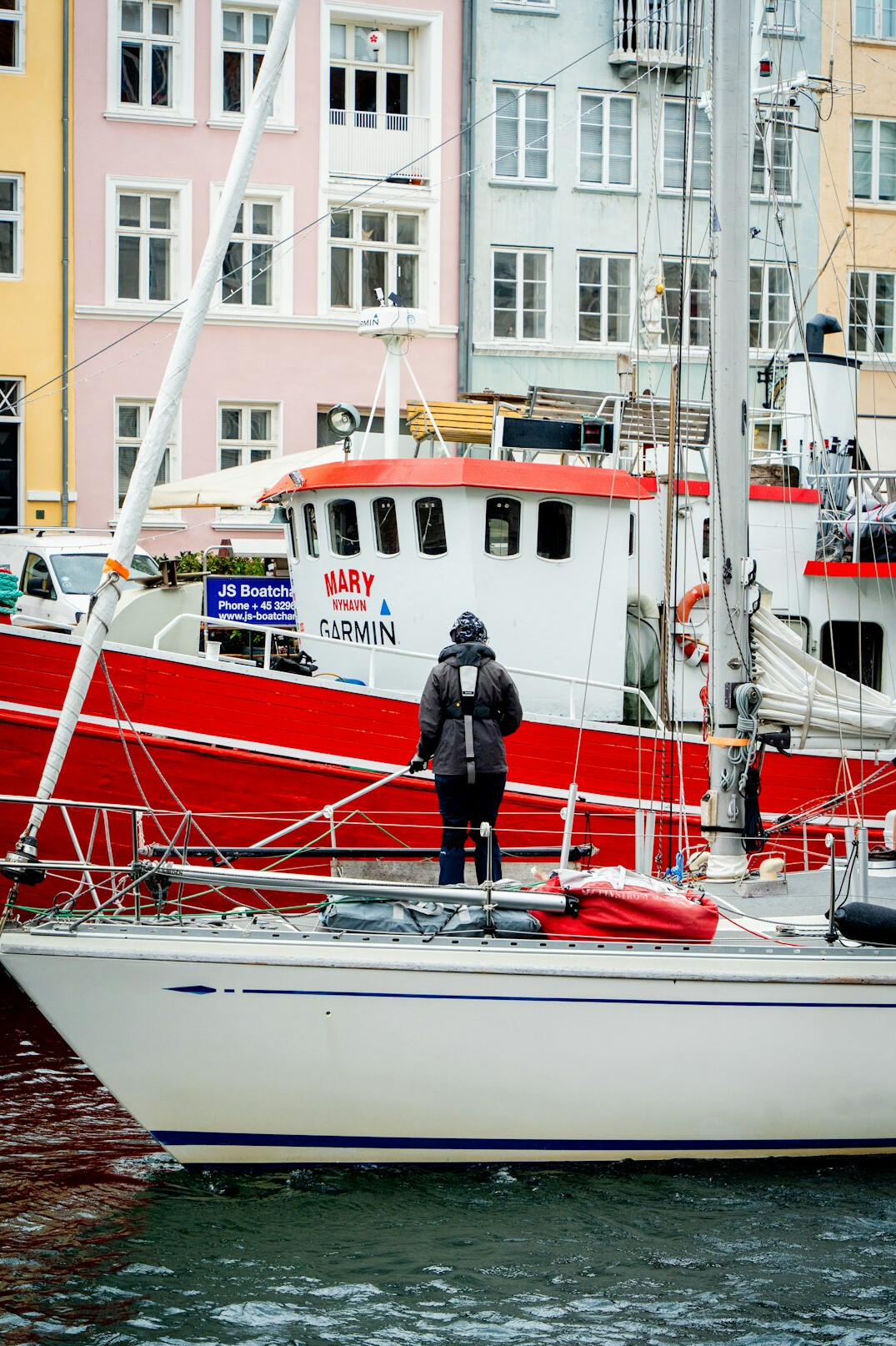 man standing by harbor in denmark