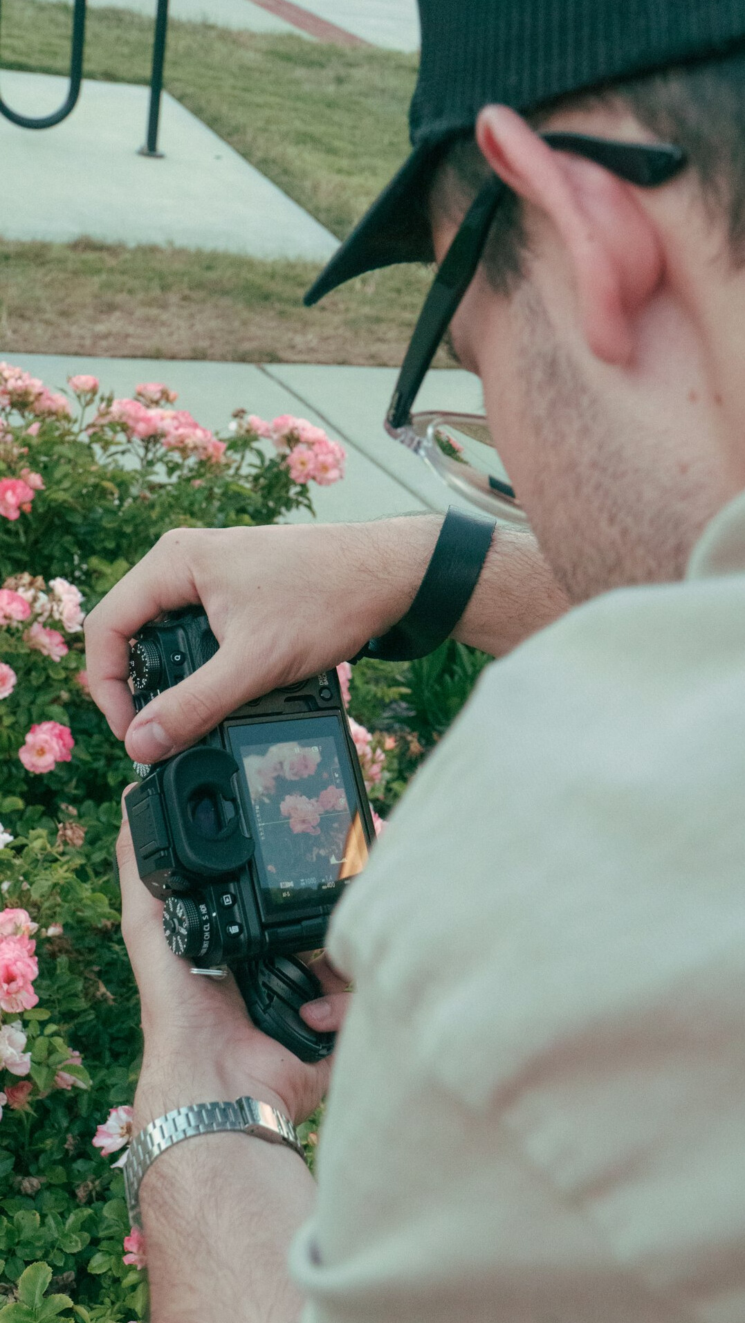 Photographer adjusting camera settings during a portrait session