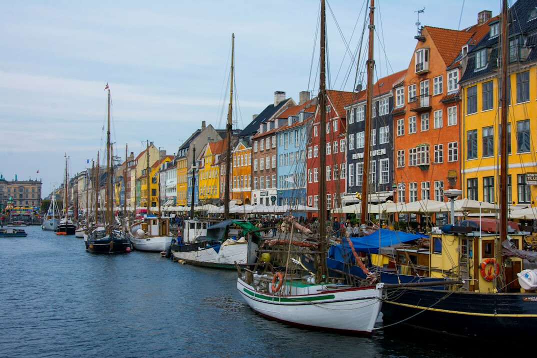 Colorful harbour houses in Nyhavn Copenhagen with boats
